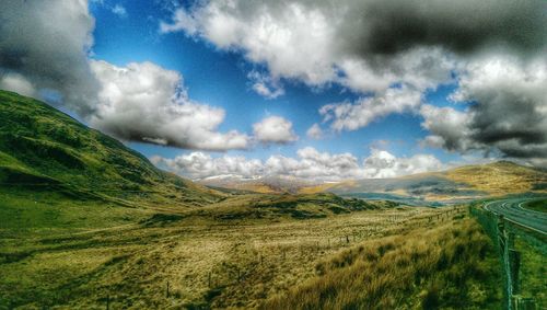 Scenic view of mountains against cloudy sky