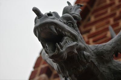 Low angle view of statue against sky