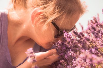 Close-up of woman with pink flower