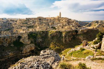 Panoramic view of buildings and rock formation against sky