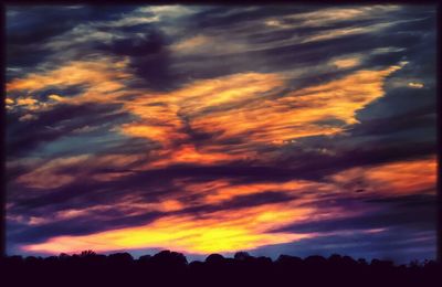 Silhouette of landscape against cloudy sky