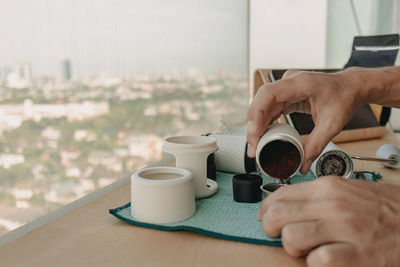Cropped hand holding coffee cup
