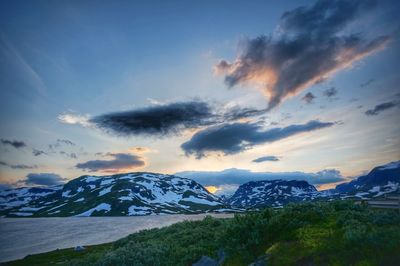 Scenic view of mountains against cloudy sky