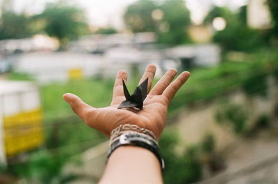 Cropped image of man with black origami