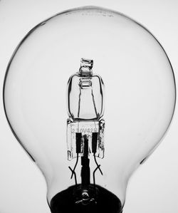 Close-up of light bulb over white background