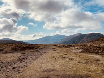 Scenic view of arid landscape against sky