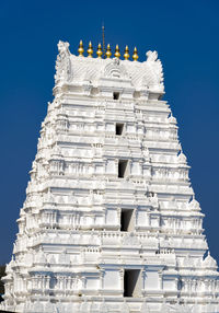 Low angle view of temple tower against blue sky