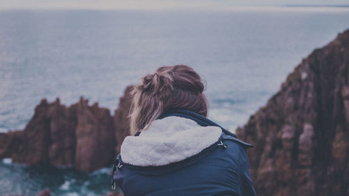 Rear view of woman looking at sea against sky