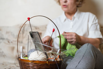 Midsection of woman holding ice cream in basket