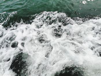 High angle view of waves splashing on rocks