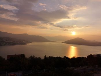 Scenic view of lake against sky during sunset