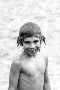 Portrait of wet shirtless boy at beach