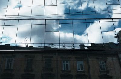 Low angle view of building against cloudy sky