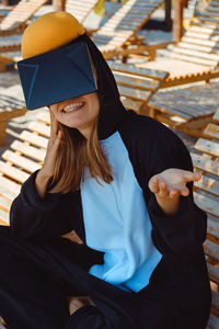 Midsection of woman sitting on bench