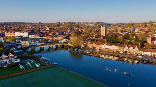 Aerial view of river amidst buildings in town