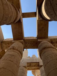 Low angle view of old ruins in egypt against clear sky