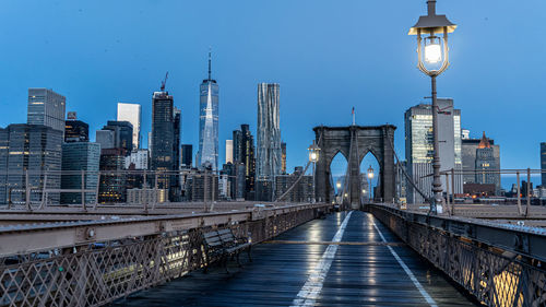 Bridge in city against clear sky