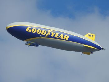 Low angle view of airplane flying against sky