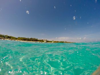 Close-up of sea against blue sky