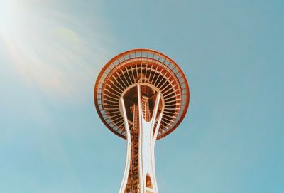 Low angle view of ferris wheel against blue sky