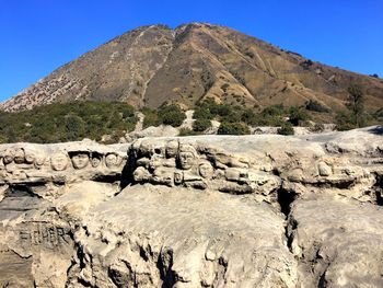 Carvings on rock formations against mountain