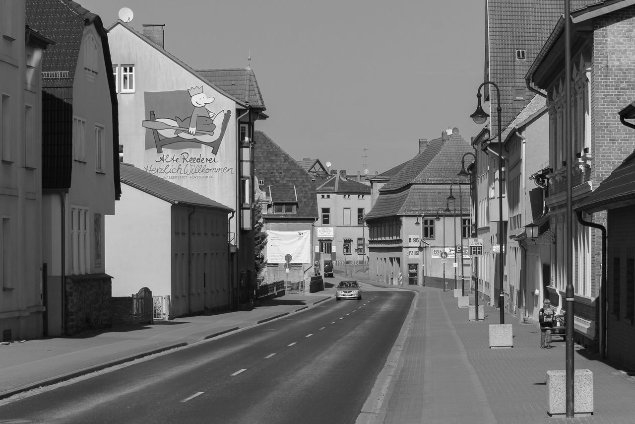 STREET AMIDST BUILDINGS AGAINST SKY