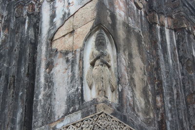 Low angle view of statue against building