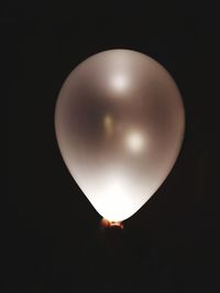 Close-up of illuminated lamp against black background