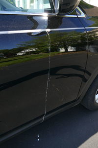 Close-up of car on road