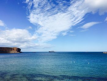 Scenic view of calm sea against cloudy sky