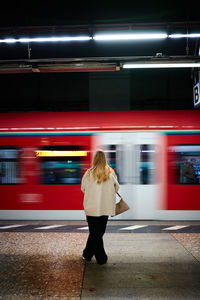 Rear view of woman walking in subway
