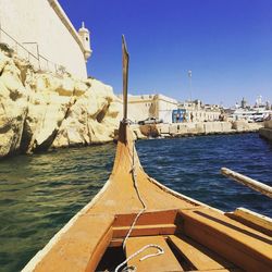 Boats in sea against clear sky