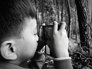 Close-up of boy playing with mobile phone