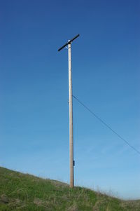Electricity pole on field