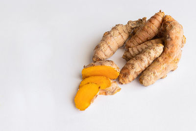 High angle view of orange fruit against white background