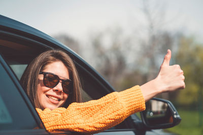 Portrait of young woman in car