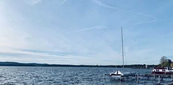 Sailboats in sea against sky