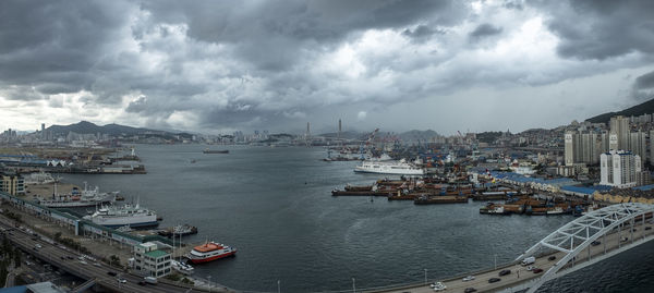 High angle view of cityscape by sea against sky