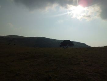 Scenic view of mountains against cloudy sky