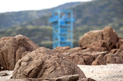 Close-up of rocks on shore against blurred background