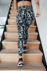 Low section of woman walking on staircase