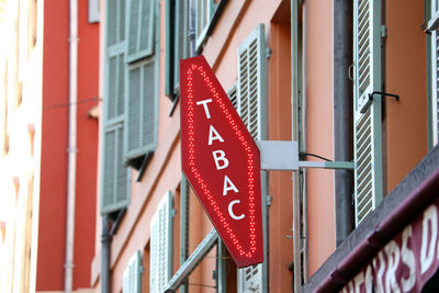 Low angle view of red flags hanging on building