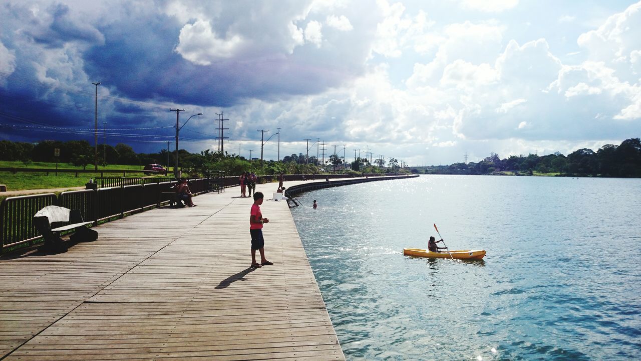 water, men, sky, lifestyles, leisure activity, cloud - sky, person, nautical vessel, cloudy, waterfront, transportation, nature, lake, sea, large group of people, river, cloud, day