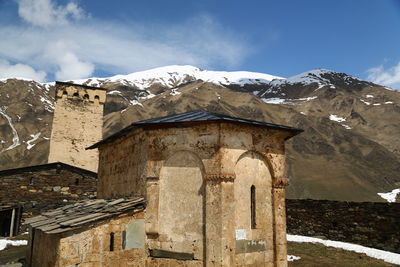 Low angle view of old building against sky during winter