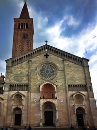 Low angle view of historical building against cloudy sky