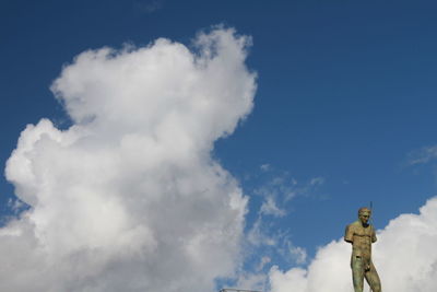 Low angle view of statue against blue sky