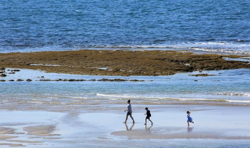 People on beach by sea