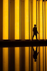 Silhouette people standing in tunnel