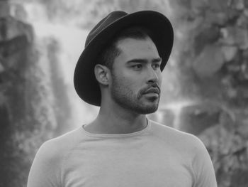 Close-up of thoughtful young man wearing hat