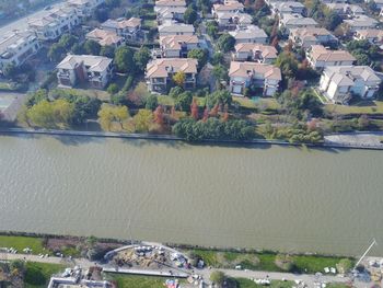 High angle view of houses by river in town